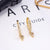 Brinco Argola Zirconia Letras - Sua Boutique